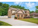 Spacious home with attached garage and long driveway provides ample parking, and features a well maintained lawn at 245 Tapestry Dr, Mcdonough, GA 30252