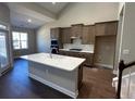 Open kitchen layout with an island, granite countertops, and stainless steel appliances at 2503 Wollerton St # 2503, Cumming, GA 30040