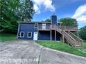 Two-story house with blue siding, a deck, stairs, and a concrete driveway at 4464 Cary Dr, Snellville, GA 30039