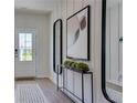 Bright foyer featuring modern decor, stylish console table, and eye-catching mirror accent, creating an inviting entry at 516 Altamaha Ct, Locust Grove, GA 30248