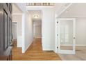 Inviting foyer with hardwood floors, white trim, and a view into multiple rooms creating an airy open concept at 5065 Hickory Hills Dr, Woodstock, GA 30188