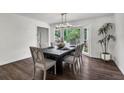 Bright dining room featuring hardwood floors, a modern chandelier, and a large bay window at 529 Greystone Trl, Marietta, GA 30068