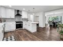 Open kitchen with white cabinets, stainless steel appliances, subway tile backsplash, and a cozy dining area at 529 Greystone Trl, Marietta, GA 30068