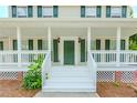 Close-up of the home's inviting front porch with white railing and a classic green front door at 855 Madison Chase Way, Lawrenceville, GA 30045