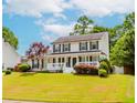 Inviting two-story home with a well-manicured lawn, front porch, and classic shutters. Beautiful curb appeal at 855 Madison Chase Way, Lawrenceville, GA 30045