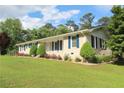 Landscaped front yard with well-manicured lawn and garden of a brick home at 175 Brookhaven Dr, Marietta, GA 30066