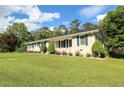 A charming home with well-manicured front yard, and lush green lawn and garden at 175 Brookhaven Dr, Marietta, GA 30066