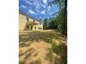Large backyard with recently laid sod and a treeline at 222 Silvercrest Dr, Acworth, GA 30101