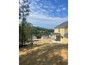 The back yard features new sod and a view of neighboring houses in the distance at 222 Silvercrest Dr, Acworth, GA 30101