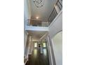 Grand two-story foyer with iron railing and open floor plan to dining and living spaces at 222 Silvercrest Dr, Acworth, GA 30101