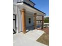 Inviting porch area with substantial wood columns and concrete entry, providing a warm welcome at 222 Silvercrest Dr, Acworth, GA 30101