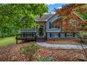 Beautiful home with stone and gray siding, a front porch, and lush landscaping at 3232 Watson Mill Dr, Loganville, GA 30052