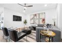 Open-concept living room with a plush sofa, modern furnishings, and large-screen TV at 371 Grant Se Cir # 1823, Atlanta, GA 30315