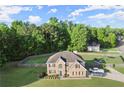 Aerial view of home with fenced backyard, basketball court and trampoline in a treed neighborhood at 423 Blackbird Way, Hampton, GA 30228