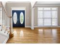 Inviting foyer with gleaming hardwood floors and a decorative glass front door at 1382 Benbrooke Nw Ln, Acworth, GA 30101