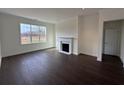 Spacious room features a cozy fireplace, natural light, and elegant hardwood floors at 1802 Bonica Xing # 1802, Cumming, GA 30040