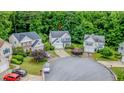 Aerial view of the white two-story home situated on a cul-de-sac and surrounded by lush greenery in a desirable neighborhood at 2022 Maple Ridge Nw Dr, Acworth, GA 30101