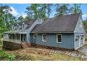 Charming home with a covered porch and two-car garage, complemented by mature landscaping and a walkway at 61 Sherwood Se Ln, Marietta, GA 30067