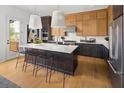 Contemporary kitchen with a large island, seating, stainless steel appliances, and bright countertops at 4850 Summerchase Ln, Cumming, GA 30028