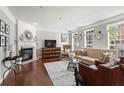 Bright living room with a fireplace, hardwood floors, and stylish decor, offering a comfortable and inviting space at 1667 Wehunt Se Pl # 11, Smyrna, GA 30082