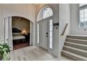 Bright entryway with a high ceiling, a staircase, and an arched doorway leading to a bedroom at 2678 Adair Trl, Dacula, GA 30019