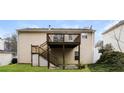 Spacious backyard featuring a wooden deck and stairs leading to the yard at 820 Tradd Ct, Stone Mountain, GA 30087