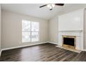 Bright living room with a fireplace, vaulted ceiling, and hardwood floors at 820 Tradd Ct, Stone Mountain, GA 30087