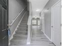 Welcoming entryway showcasing stairs, grey walls, white trim, and a glimpse into the living area at 1341 Rogers Trce, Lithonia, GA 30058
