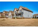 Attractive two-story house with a brick and siding exterior, complemented by a well-kept lawn at 7575 Old Camp Lndg, Cumming, GA 30040