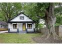 Charming exterior view of a two-story home featuring a welcoming front porch and a bright yellow front door at 1120 Arlington Sw Ave, Atlanta, GA 30310