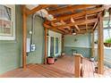 Wood porch featuring brick and wood walls, a ceiling fan, and potted plants at 2364 Woodside Way, Atlanta, GA 30341