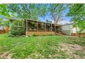 Lawn view of house with covered porch and landscaping in front at 2364 Woodside Way, Atlanta, GA 30341