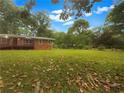 Spacious backyard with well-maintained lawn and mature trees, perfect for outdoor activities at 4261 E Conley Rd, Conley, GA 30288