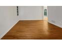 Bright living room features hardwood floors, white walls, and a large window for ample natural light at 4261 E Conley Rd, Conley, GA 30288