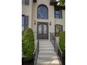 Grand front entrance with an arched window and ornate ironwork on the double doors at 818 Forest Path Ln, Alpharetta, GA 30022