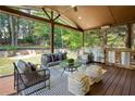 Inviting covered patio with an outdoor kitchen and comfortable seating area overlooking the backyard at 818 Forest Path Ln, Alpharetta, GA 30022