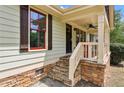 Close-up of the stone-accented front porch with painted columns and a ceiling fan at 2074 Hilburn Se Dr, Atlanta, GA 30316