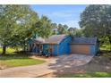 The front of this single story home features a 2-car garage and a quaint covered porch at 483 Glen Terrace Rd, Auburn, GA 30011