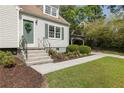 Welcoming home exterior featuring a well-kept lawn, landscaped garden beds, and a charming covered carport at 1972 Wingate Rd, Chamblee, GA 30341