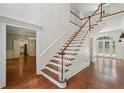 Bright foyer showcasing hardwood floors, staircase, and entryways to adjacent rooms at 200 River Pass Trl, Atlanta, GA 30350