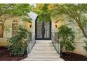 Elegant entryway featuring a wrought iron double door and stone steps at 200 River Pass Trl, Atlanta, GA 30350