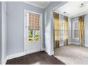 Versatile room with carpet, curtains, and a backyard view at 2222 Haventree Ct, Lawrenceville, GA 30043