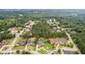 An aerial view showcases a neighborhood surrounded by lush greenery and beautiful homes at 3364 Kylee Dawn Cir, Lawrenceville, GA 30045