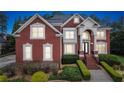 Beautiful red brick two-story home with manicured landscaping and a grand entrance at 3364 Kylee Dawn Cir, Lawrenceville, GA 30045