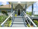 Inviting front porch with sleek railing and gray stairs, enhancing the curb appeal of this home at 4940 Sunrise Ln, Cumming, GA 30041