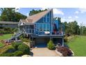 Beautiful home with a deck and under-house garage, enhanced by professionally landscaped surroundings at 4940 Sunrise Ln, Cumming, GA 30041