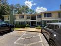 Exterior view of the two-story condo building with well-maintained landscaping and ample parking at 1251 Branch, Tucker, GA 30084