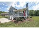 Well-maintained two-story home with a front porch, landscaped yard, and driveway on a bright day at 37 Faithful Dr, Temple, GA 30179
