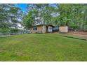Well-maintained front yard with a cozy house and a charming shed at 5400 Kings Camp Rd Se #C1 Se Rd, Acworth, GA 30102