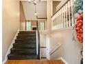 Grand foyer with dark wood staircase and railing, light walls, and hardwood flooring creating a bright and inviting entrance at 90 Camden Woods Pl, Dallas, GA 30157
